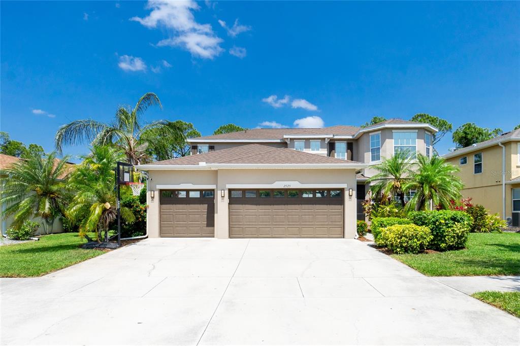 a front view of a house with a yard and garage