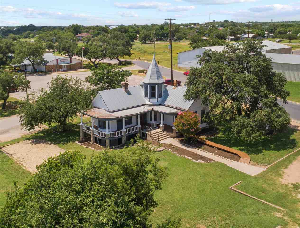 an aerial view of residential houses with outdoor space and river