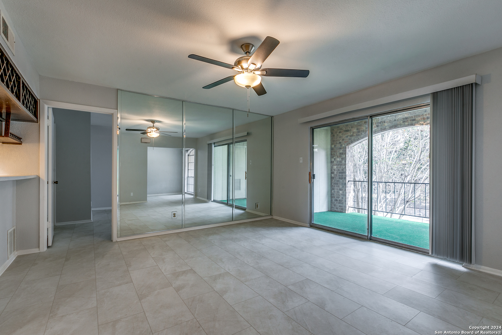 a view of a livingroom with a ceiling fan and window