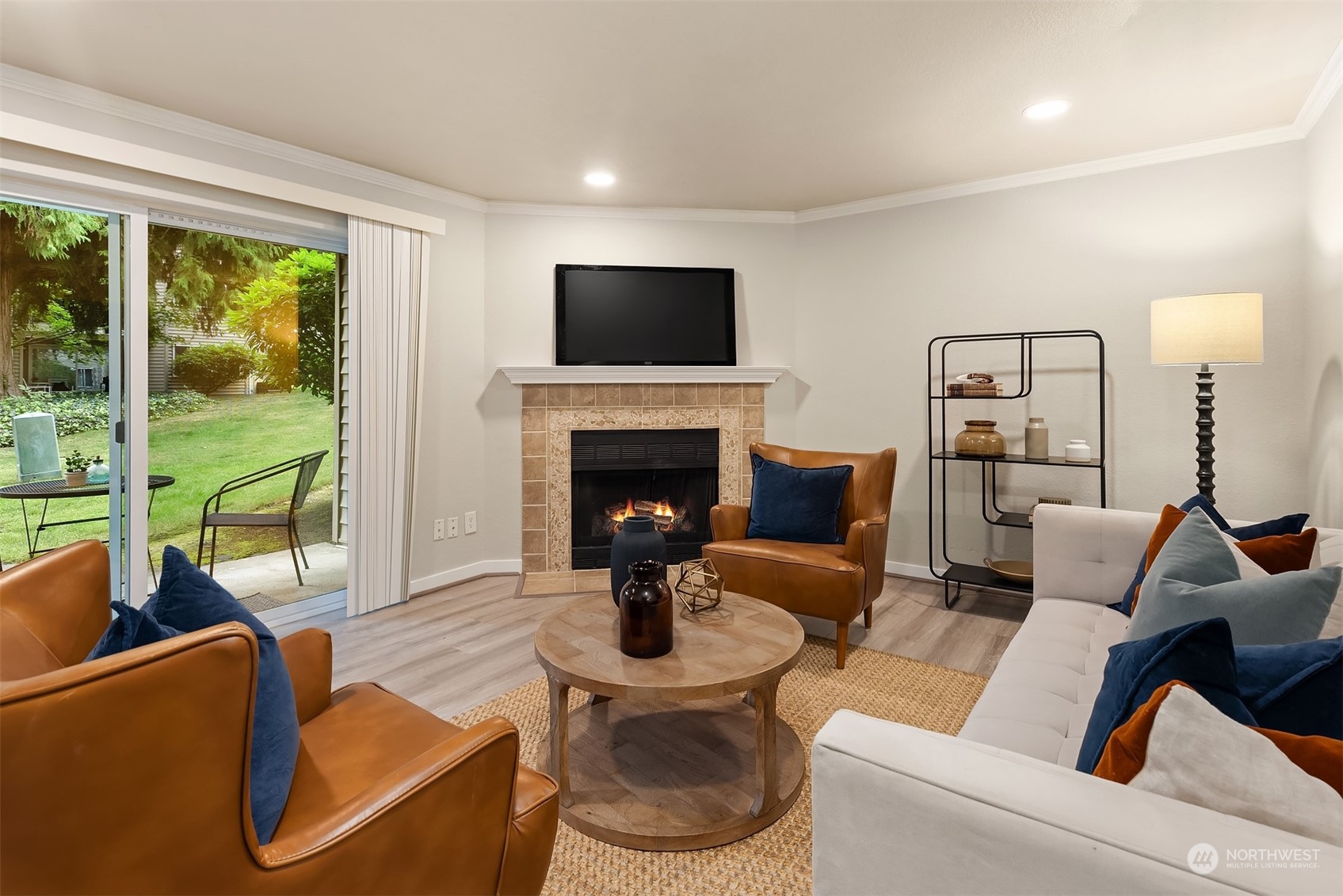 a living room with furniture a large window and a fireplace