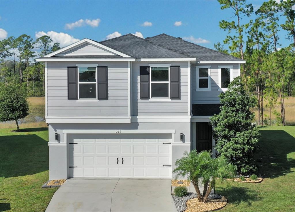 a front view of a house with a yard