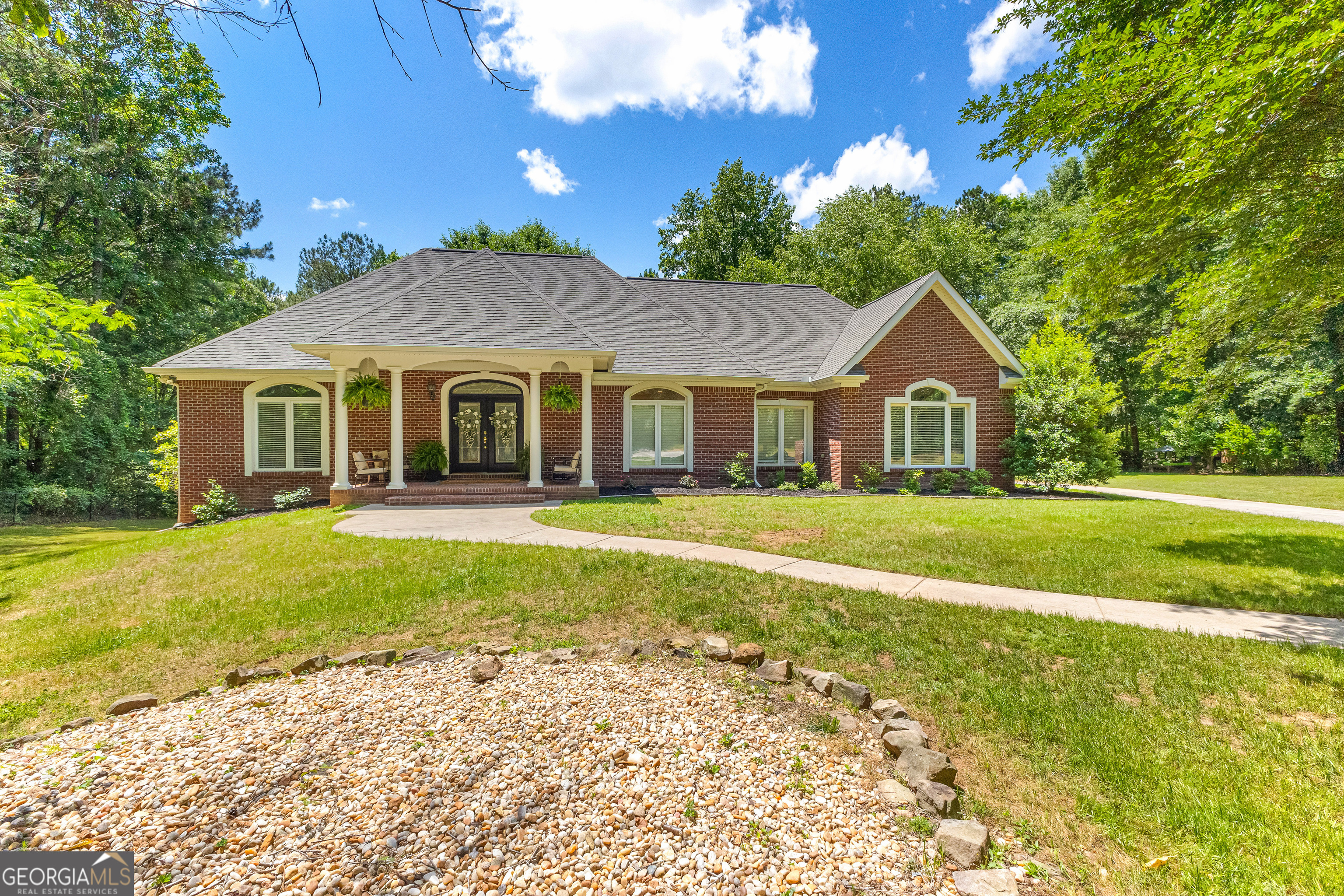 a front view of a house with garden