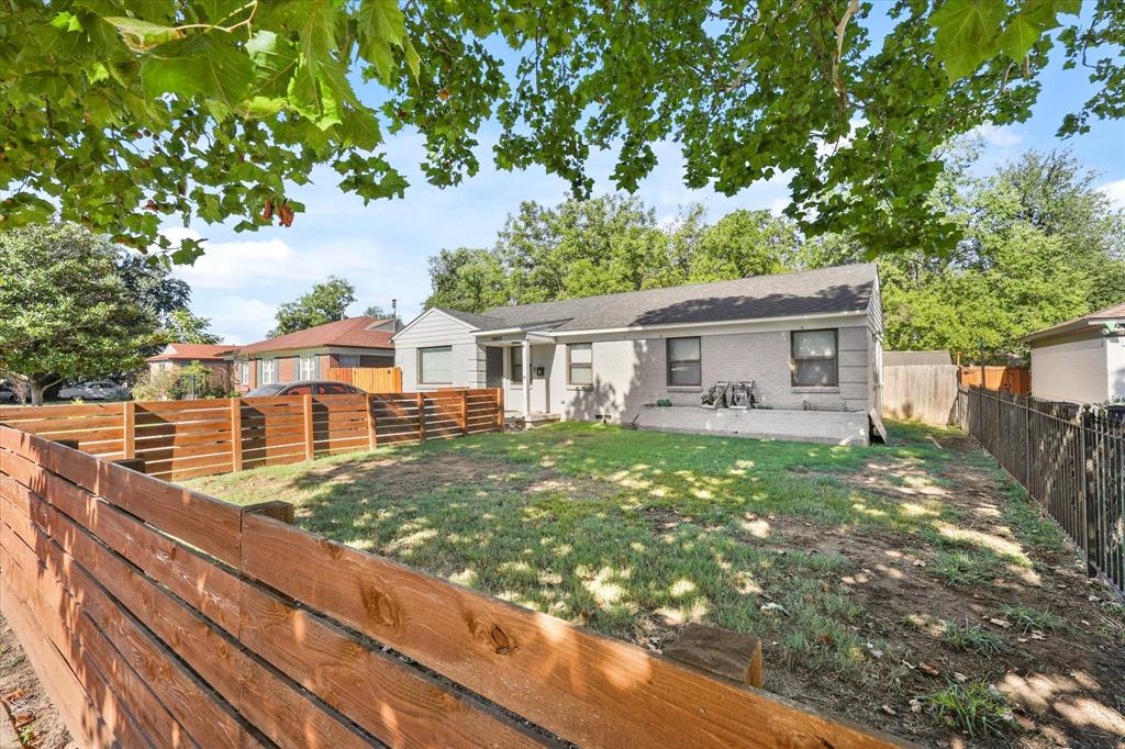 Rear view of house featuring a yard and a patio area