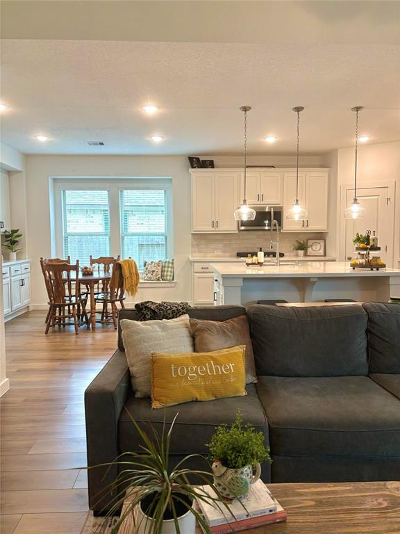 a kitchen with a table chairs stove and kitchen view