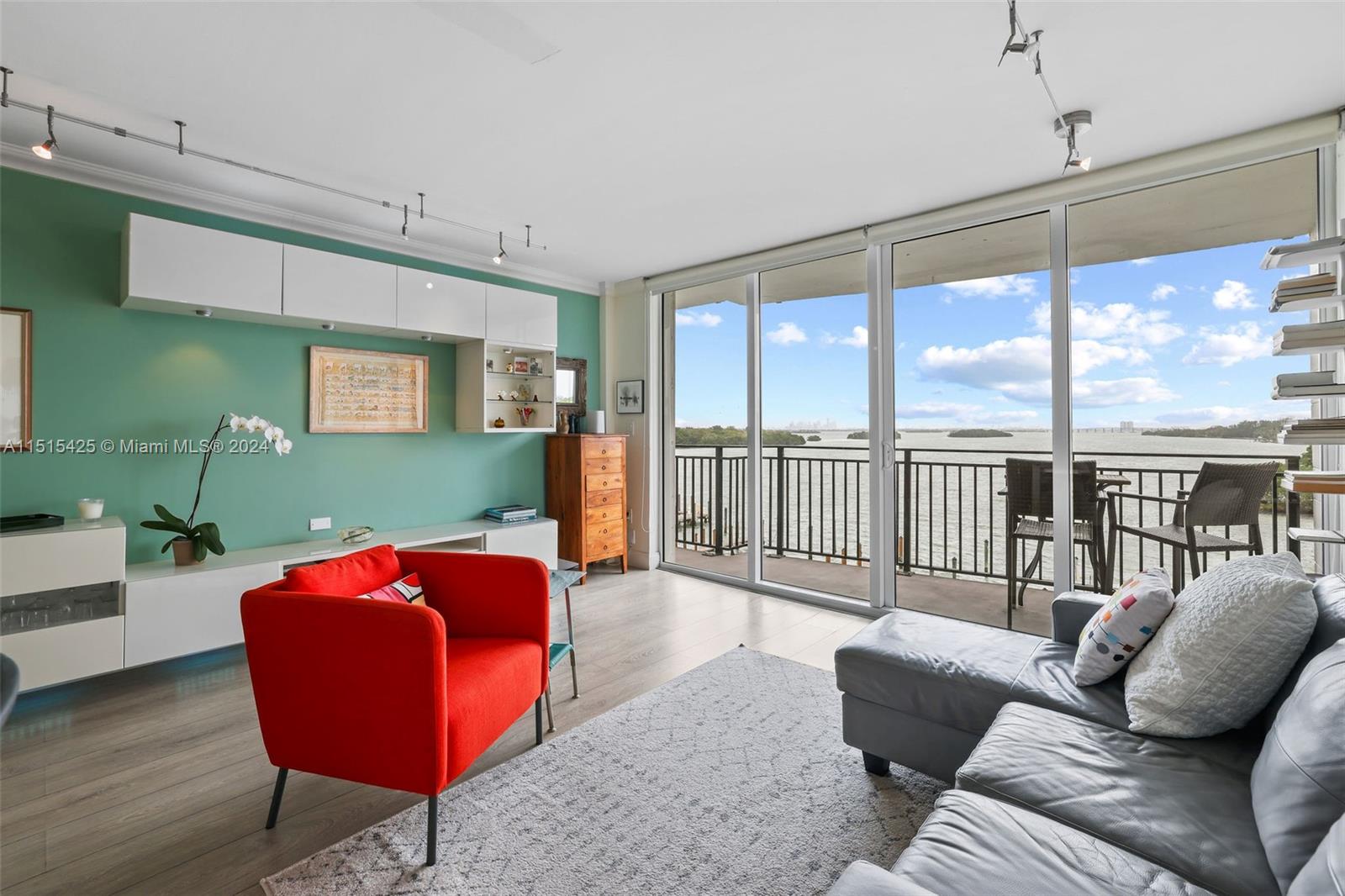 a living room with furniture and a floor to ceiling window