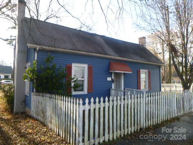 a front view of a house with a fence