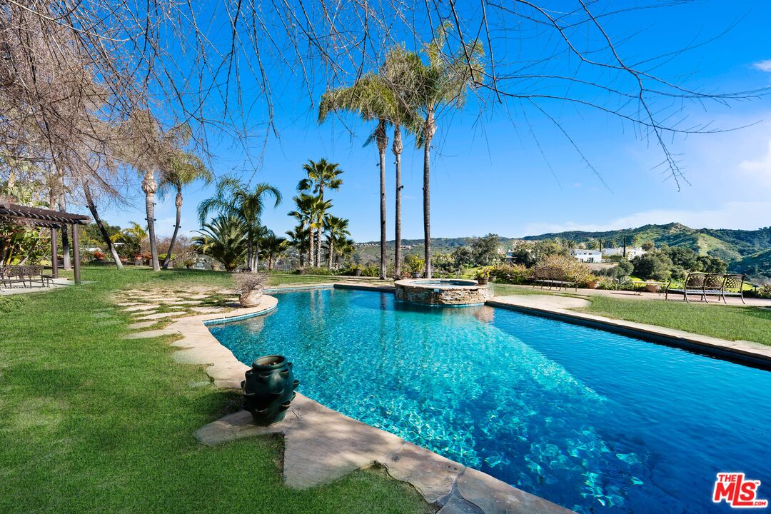 a swimming pool with outdoor seating and yard