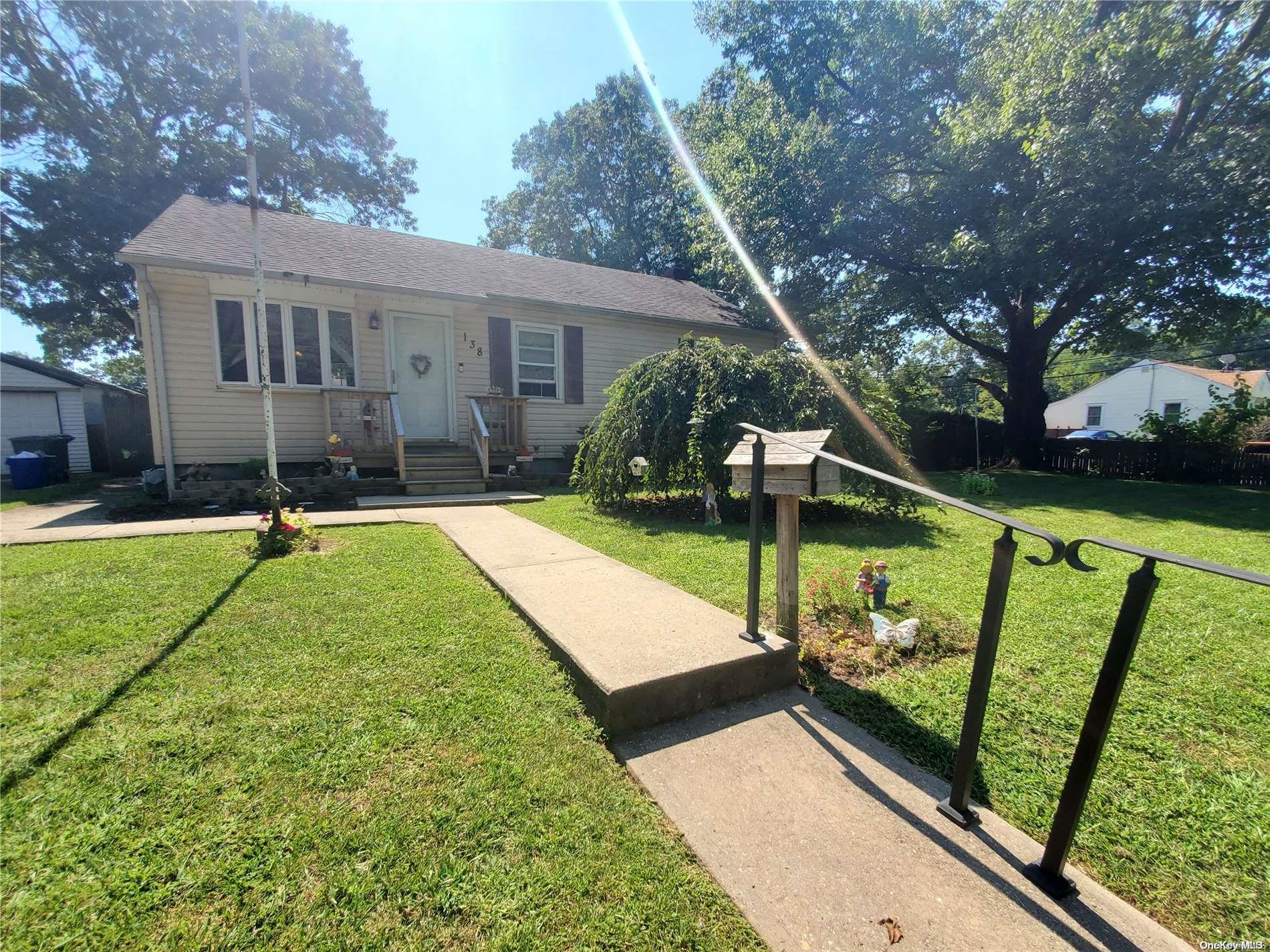 a view of a house with backyard and a patio