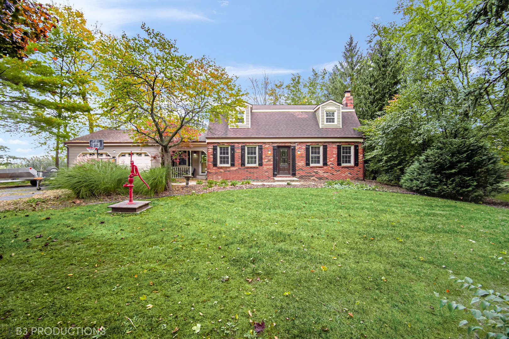 a view of a house with a backyard and a patio