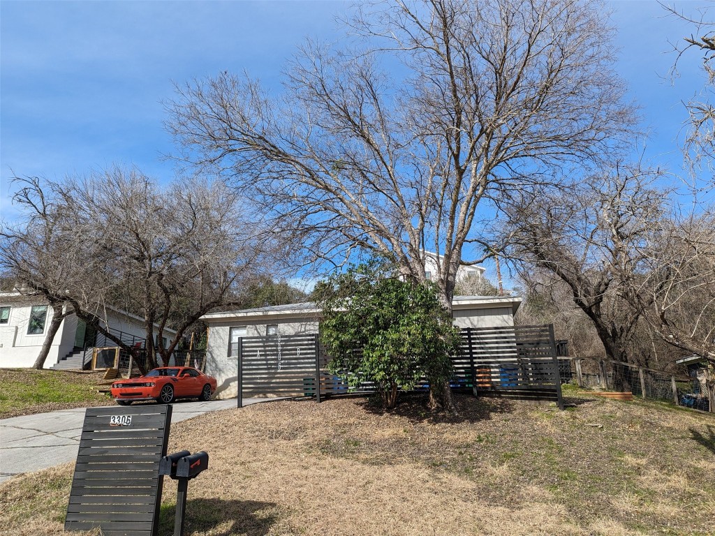 a view of a house with a yard and trees