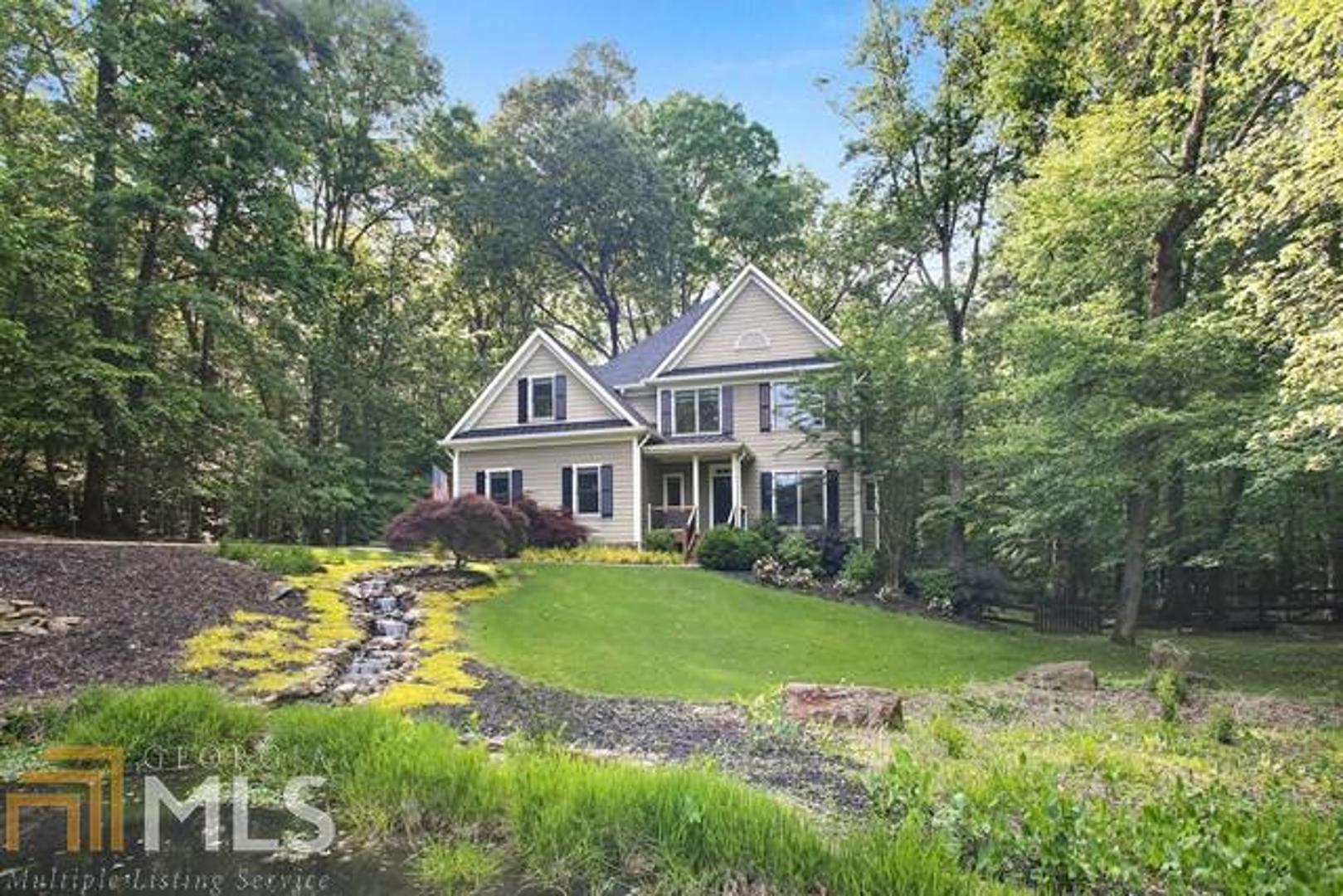 a front view of a house with a garden