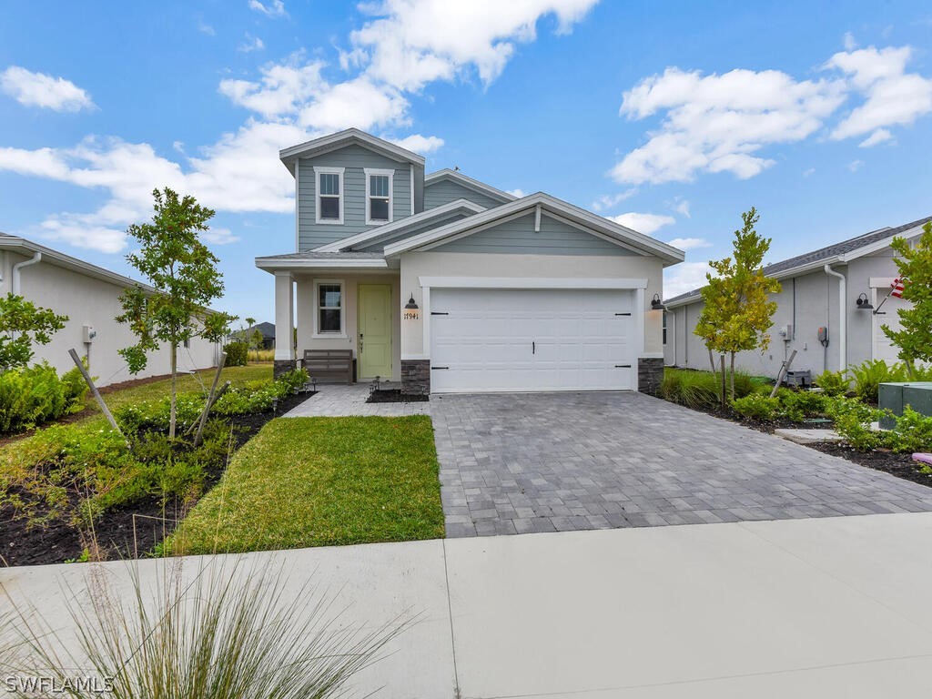 a front view of a house with a yard and garage