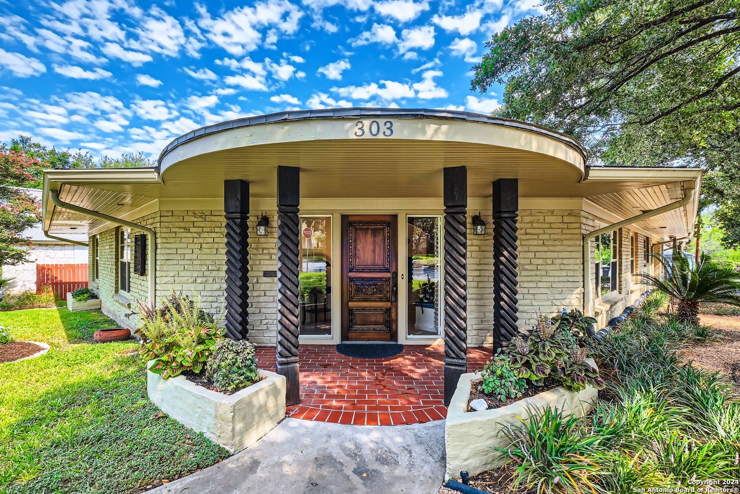 a front view of a house with garden