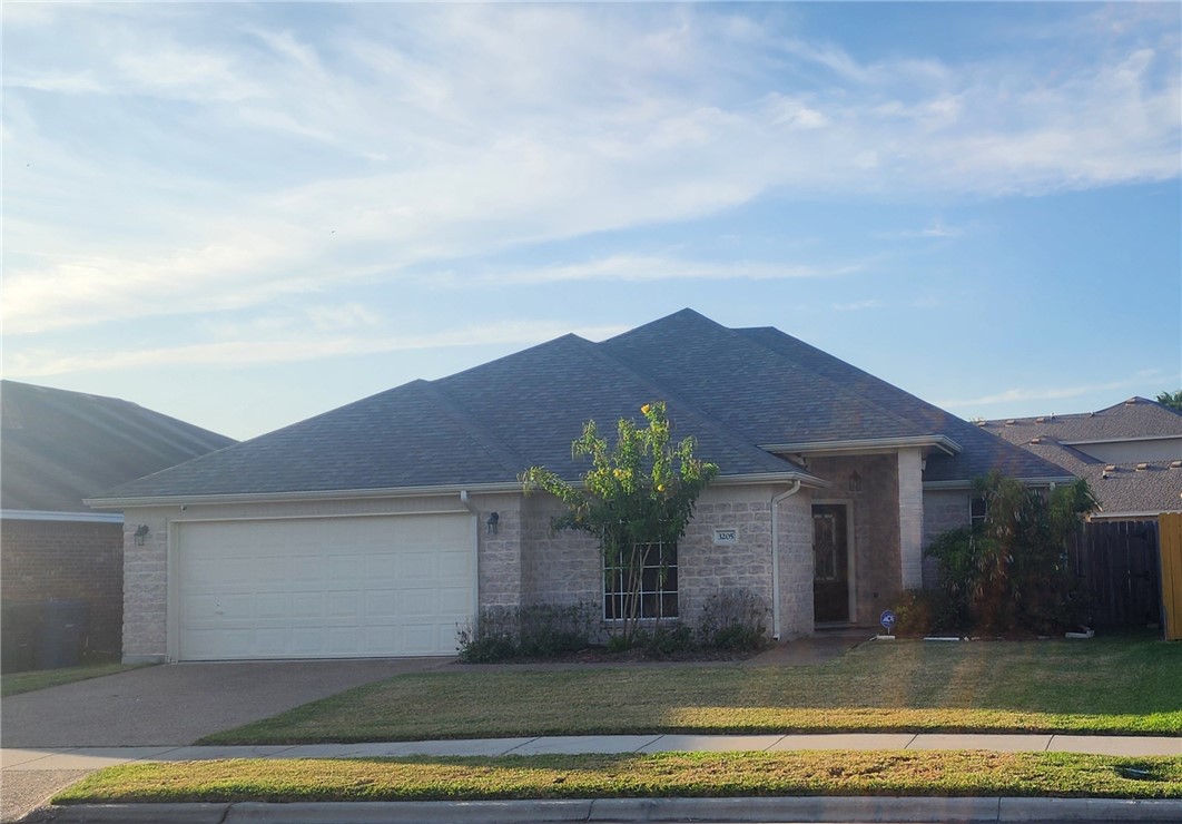 a front view of a house with a yard and garage