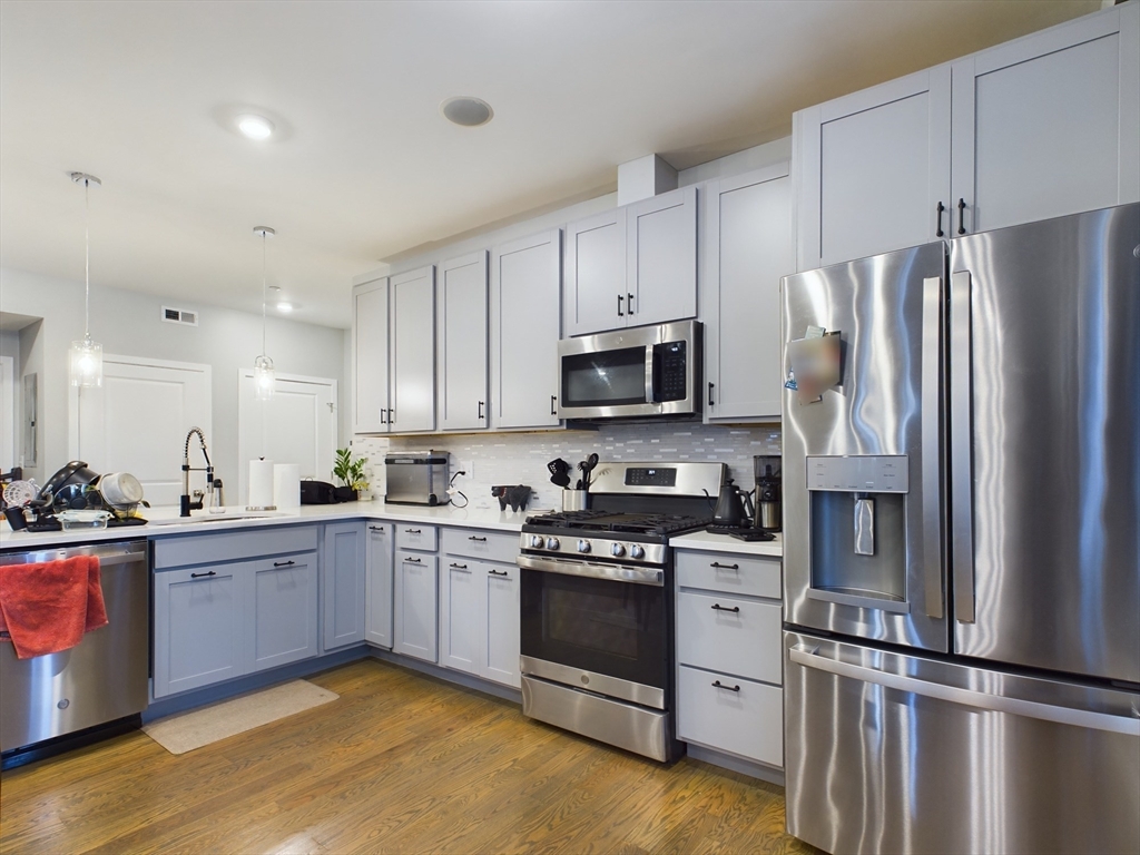 a kitchen with a sink stove and refrigerator