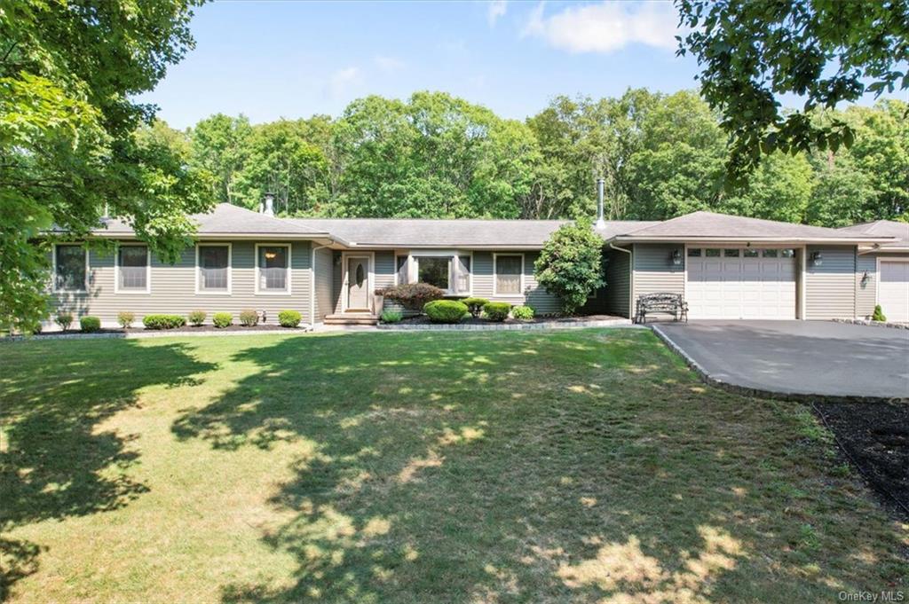 a front view of house with yard and green space