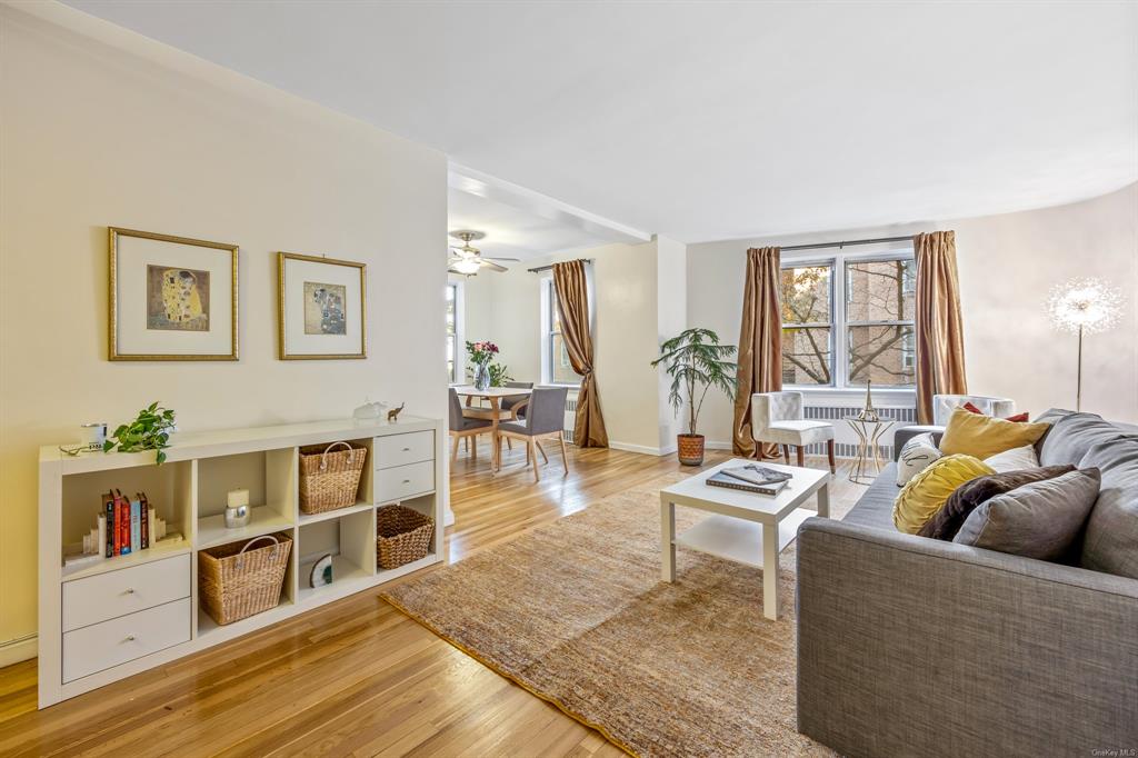 Living room featuring ceiling fan and light hardwood / wood-style flooring