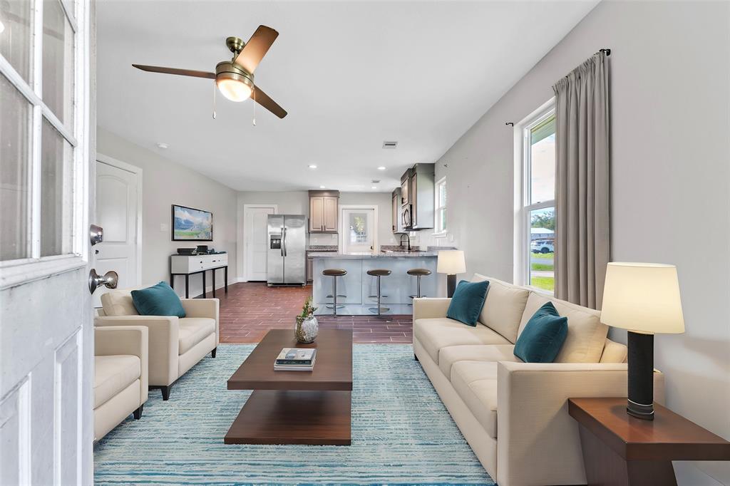 a living room with furniture and a lamp