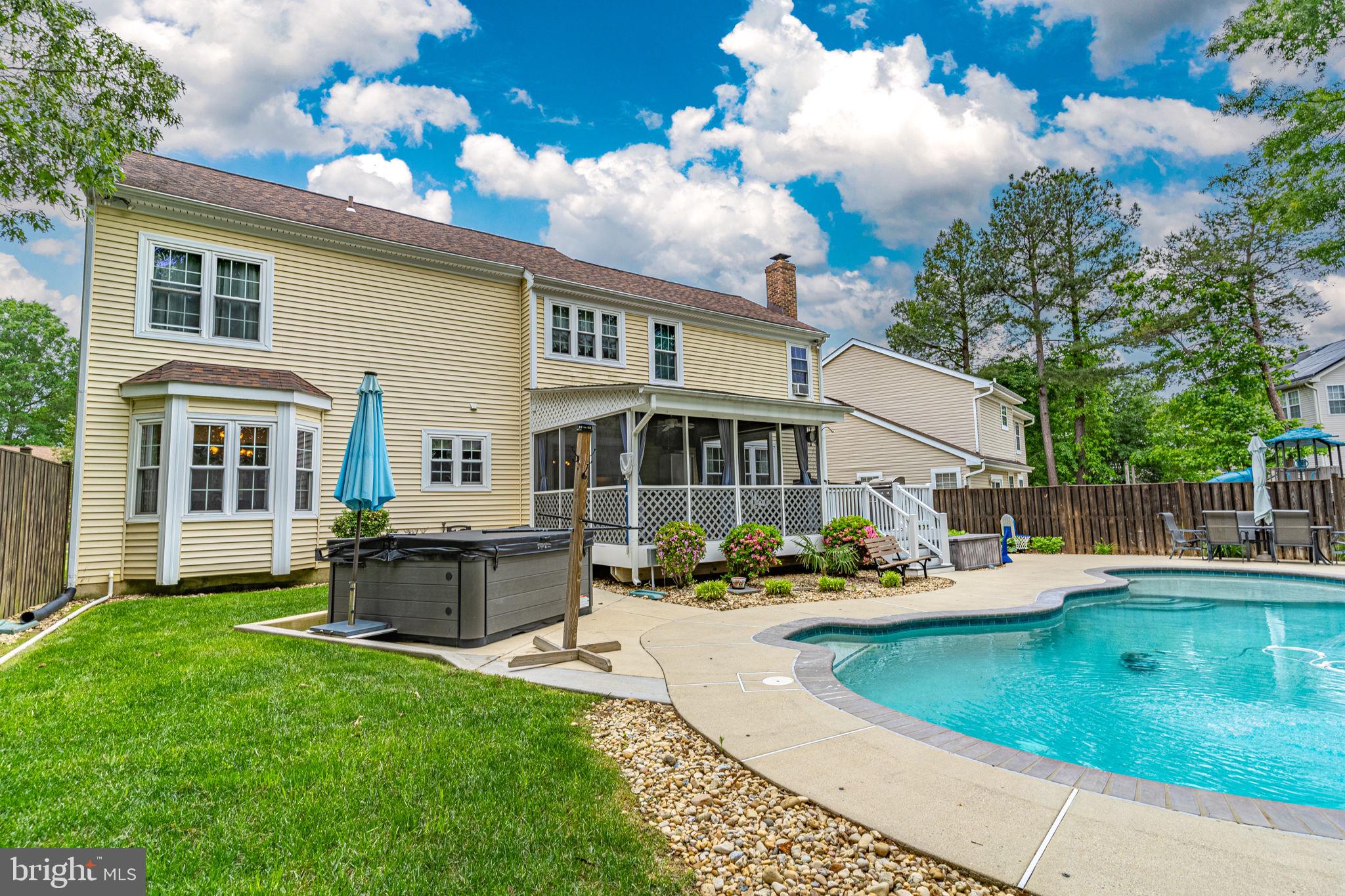 a front view of a house with swimming pool having outdoor seating