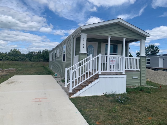 a view of a house with wooden deck and a yard