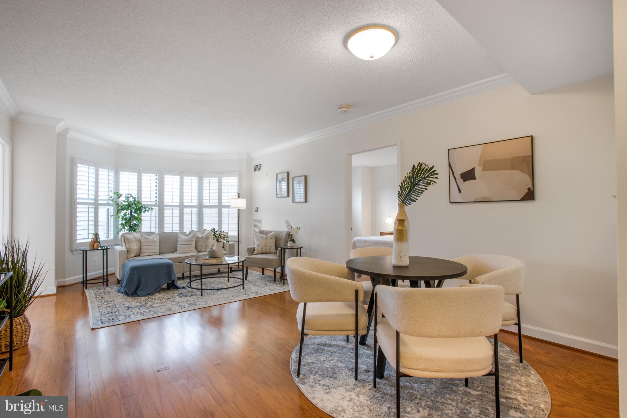 a dining room with furniture and wooden floor