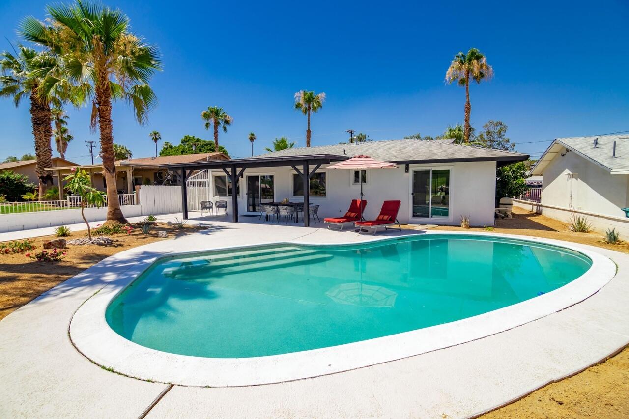 a swimming pool with outdoor seating yard and barbeque oven