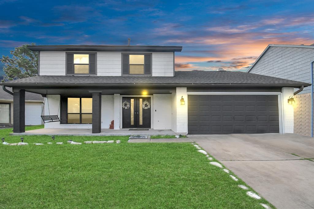 a front view of a house with a yard and garage