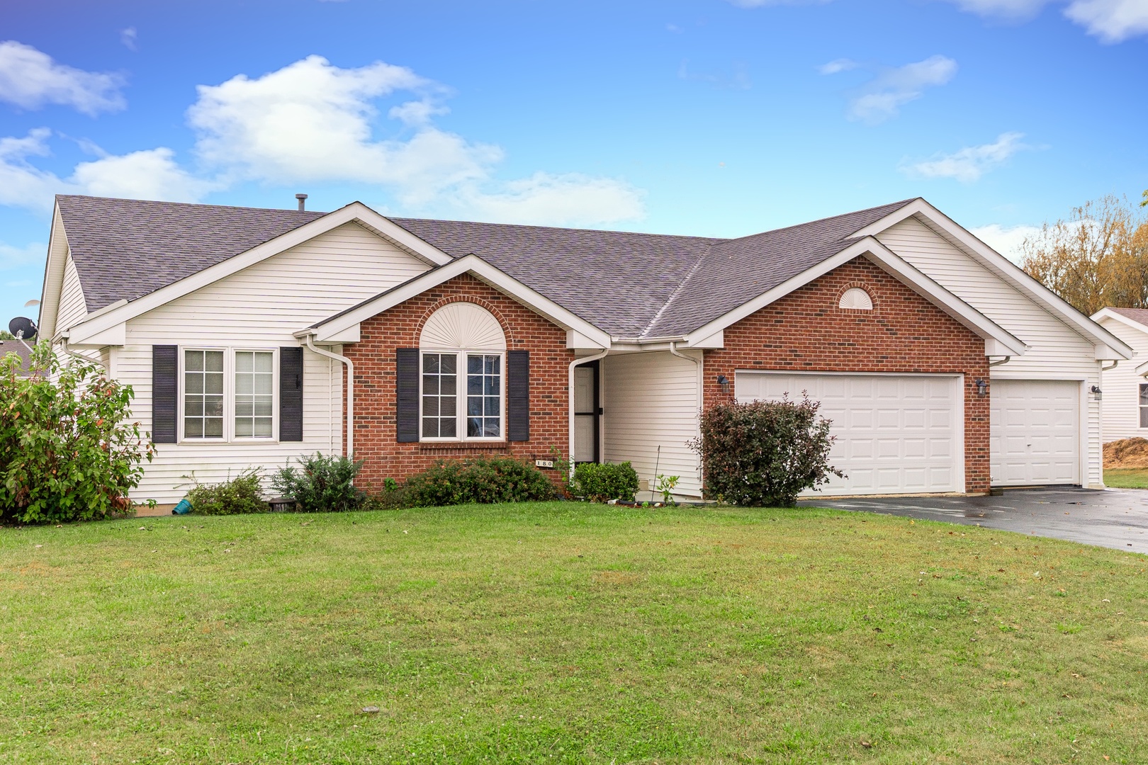 a front view of house with yard and green space