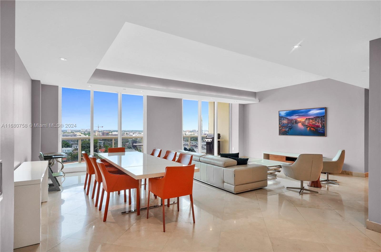 a view of a livingroom with furniture and a dining table