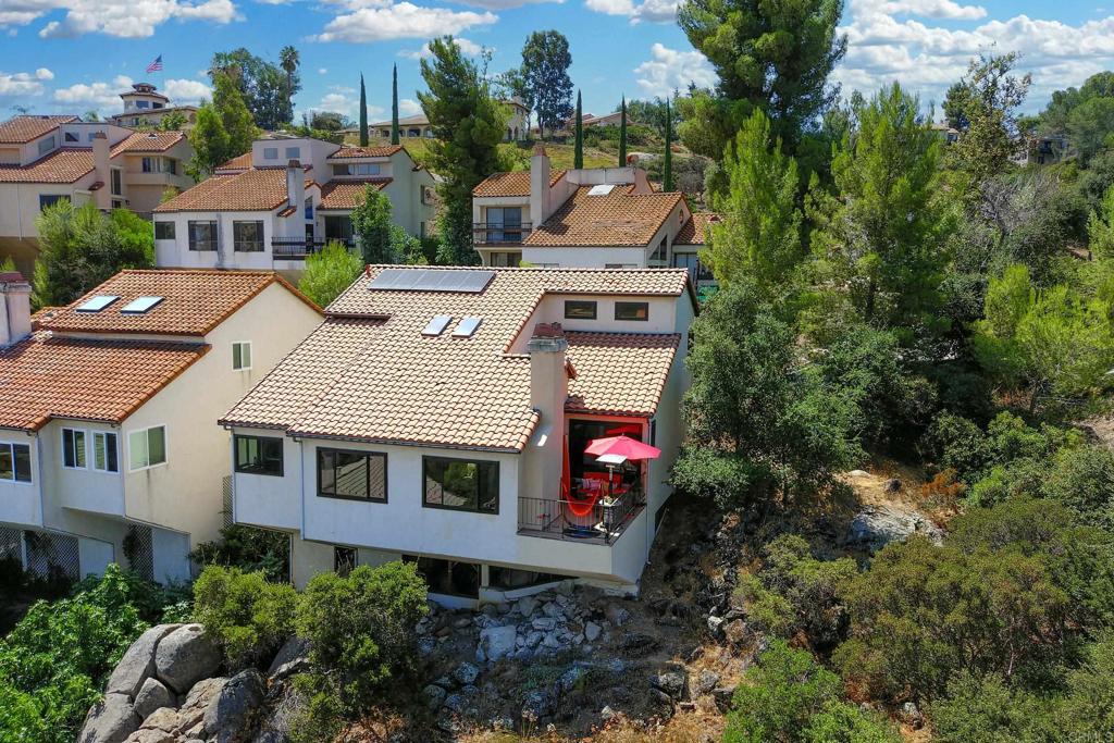 an aerial view of multiple houses with a yard