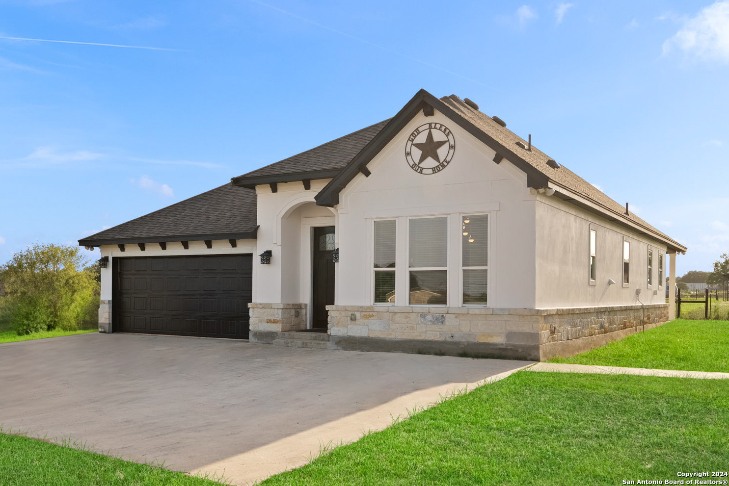 a front view of a house with a yard and garage