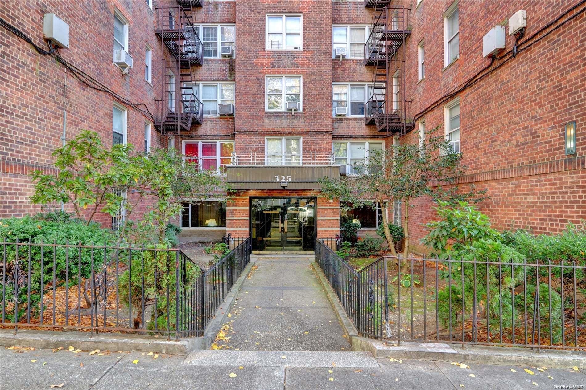 a front view of a building with garden