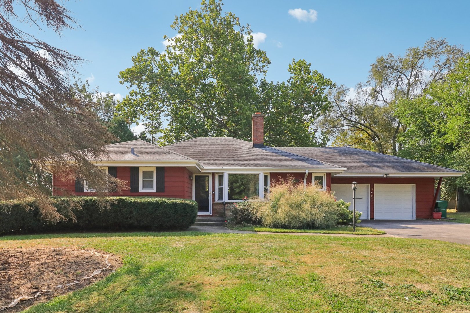 a front view of a house with a garden