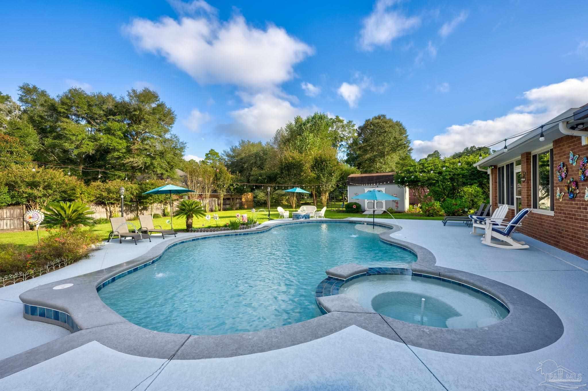 a view of a swimming pool with a yard