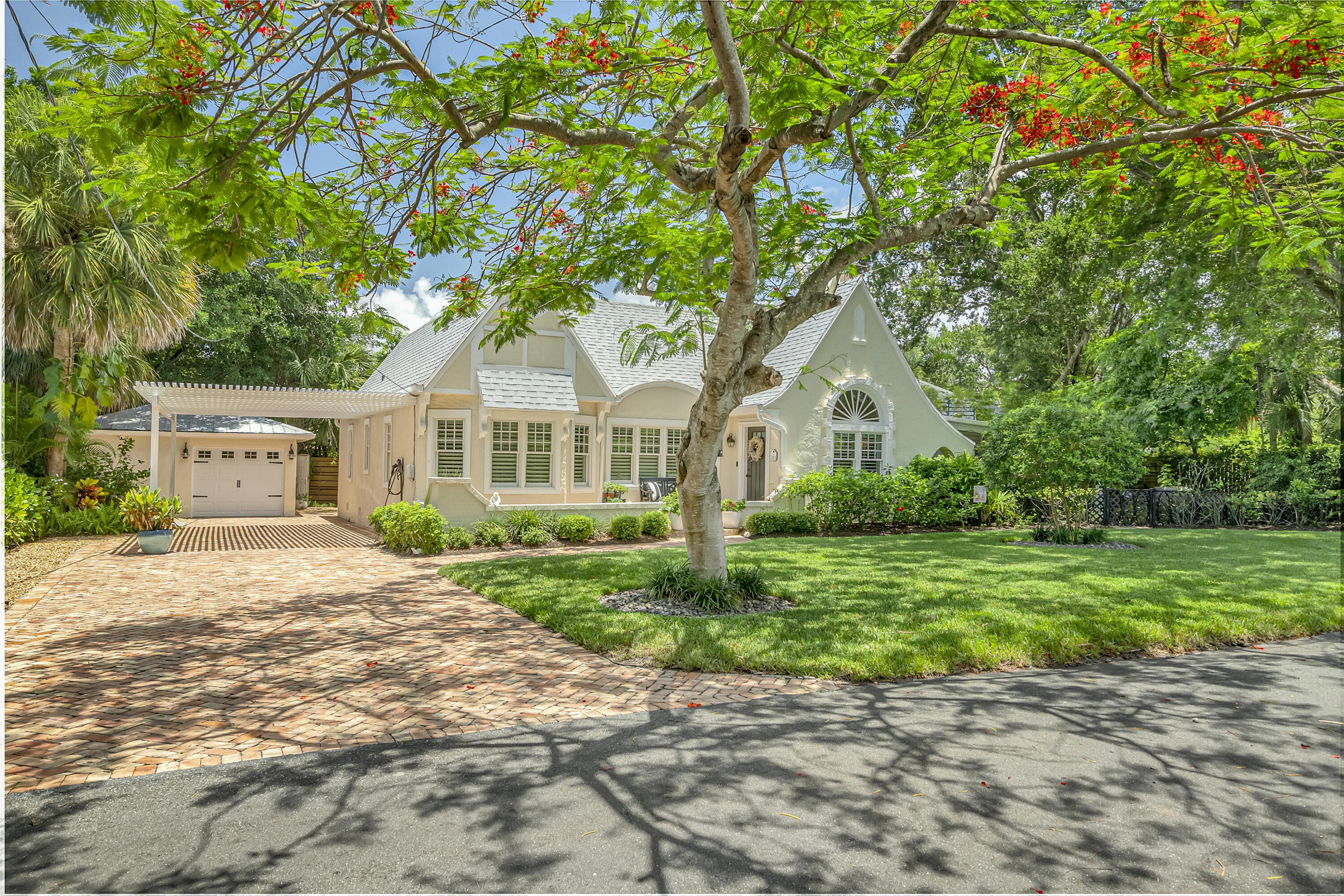 a front view of a house with a garden and yard