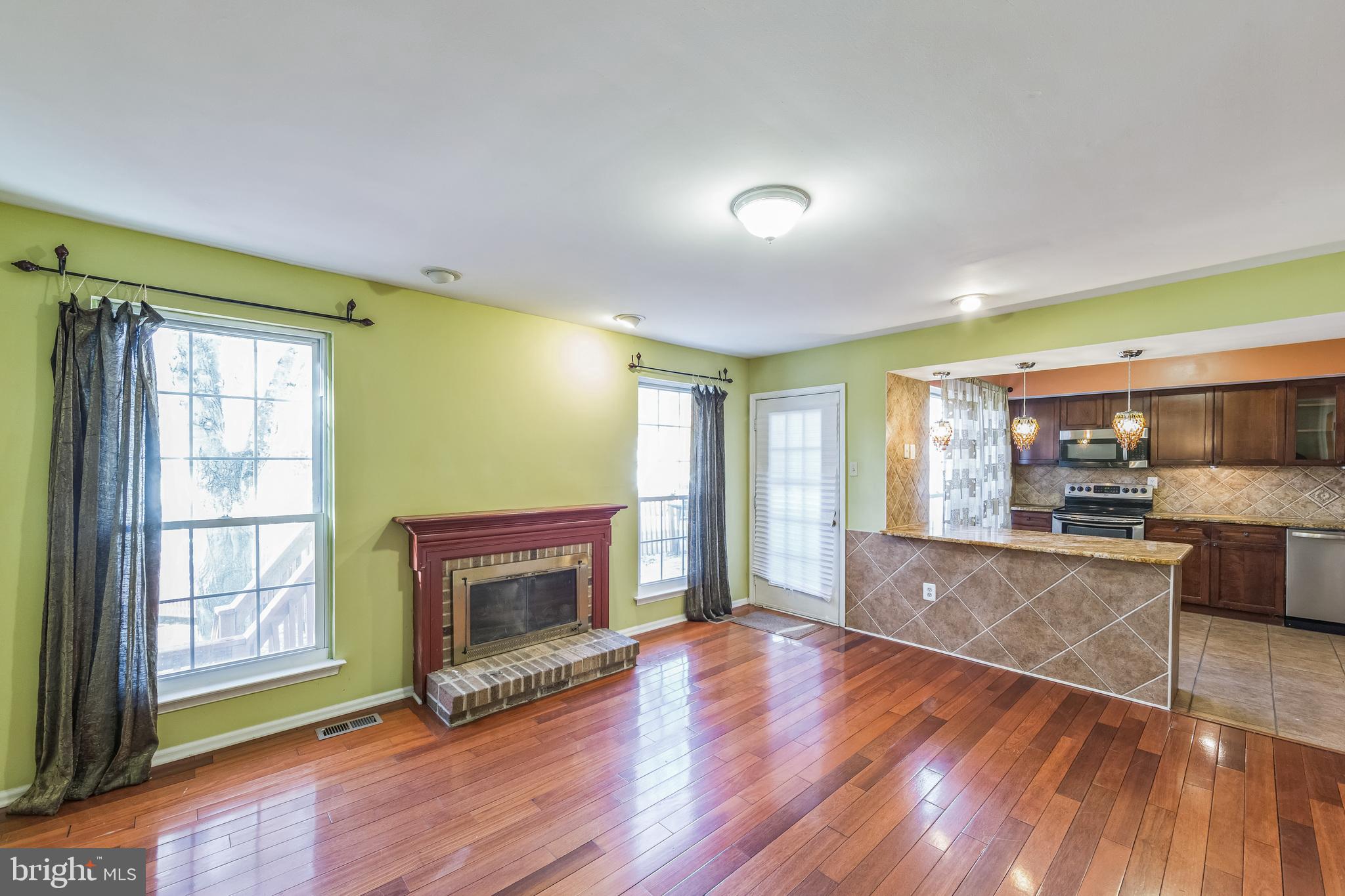 a view of kitchen with livingroom and fireplace