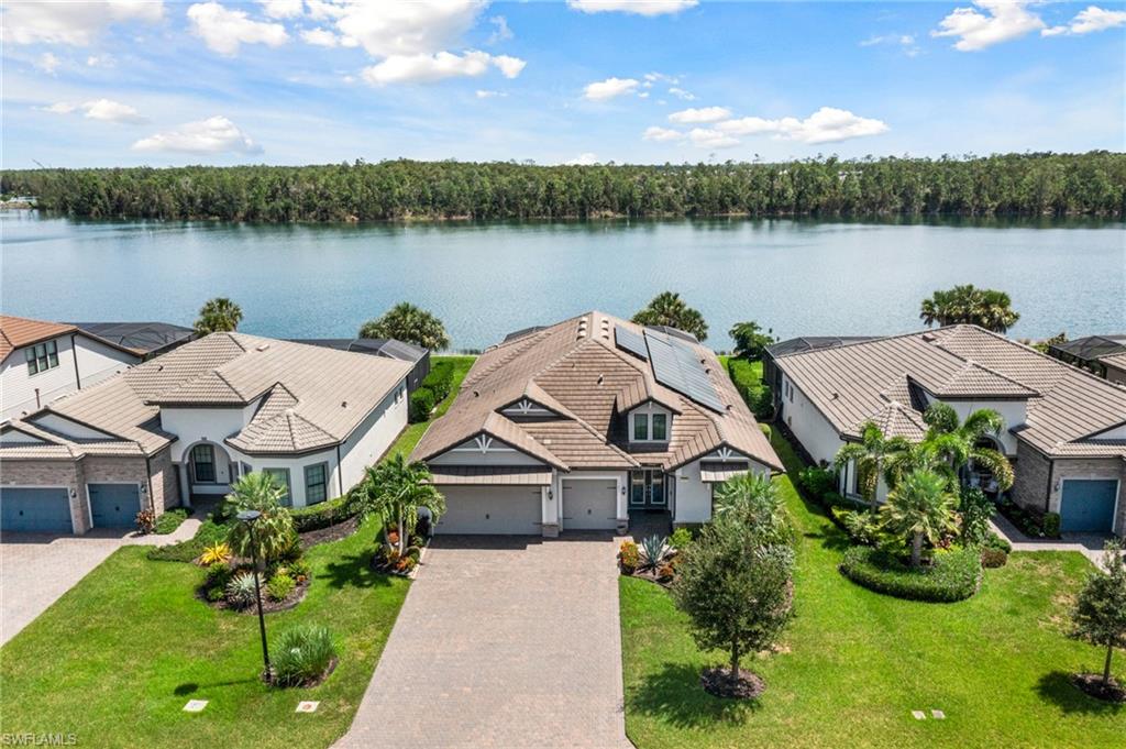 a aerial view of a house with pool and a yard