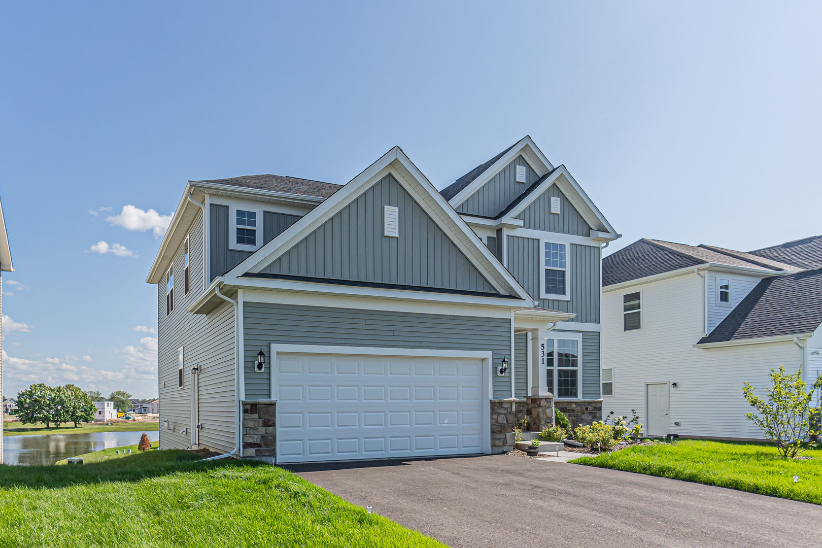 a front view of a house with a yard and garage