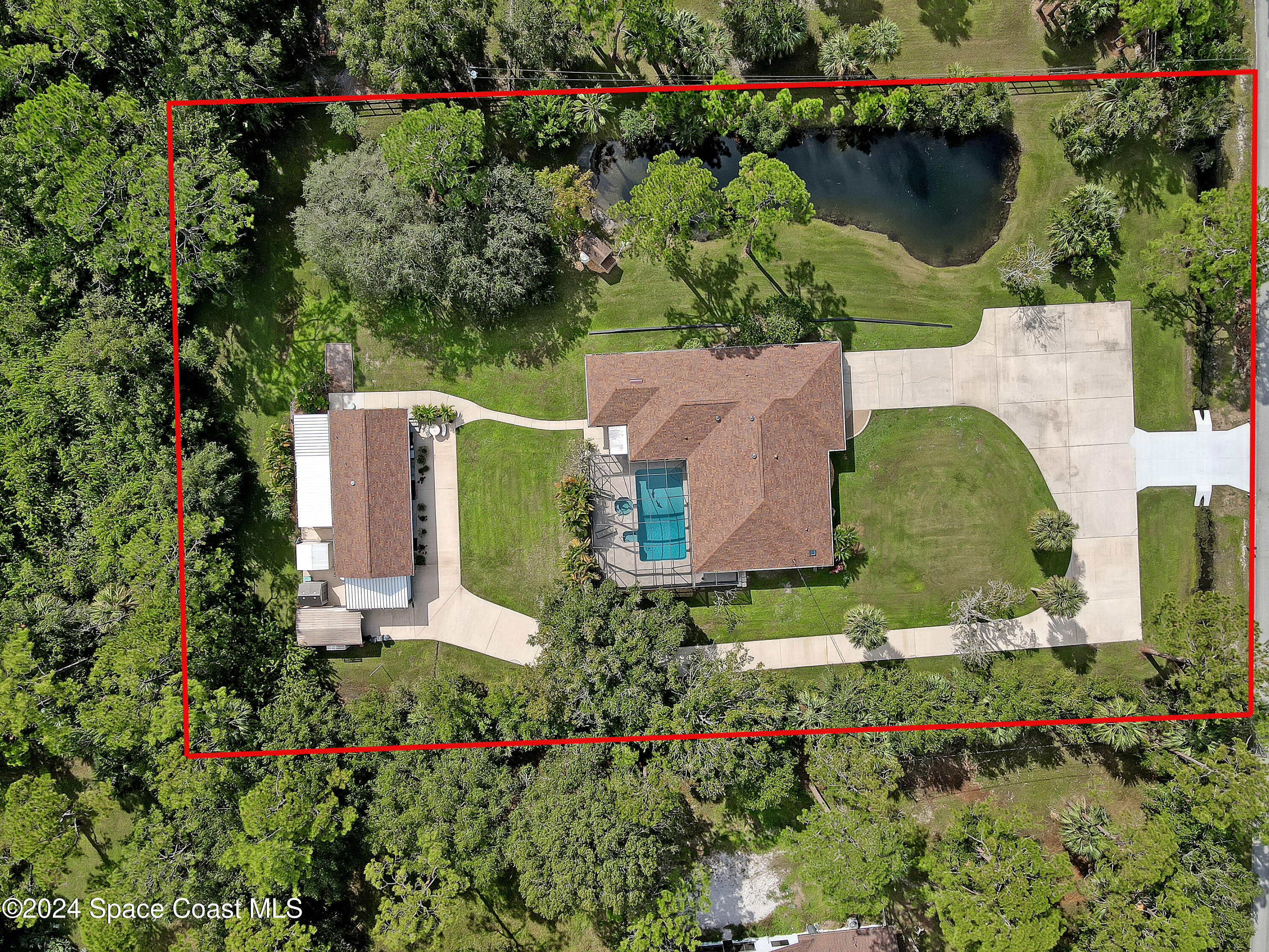 an aerial view of a house with a garden and swimming pool