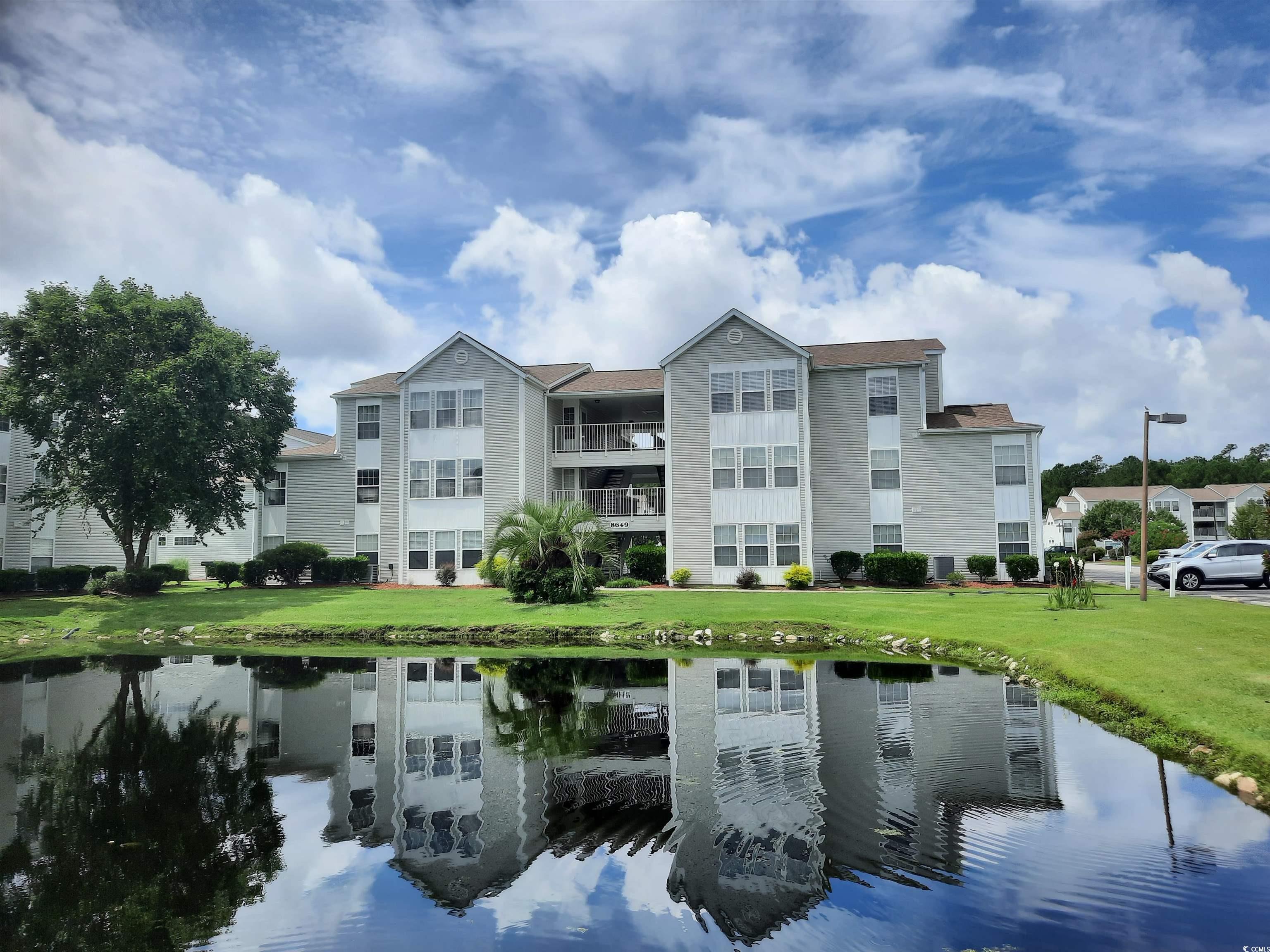 View of property with a water view