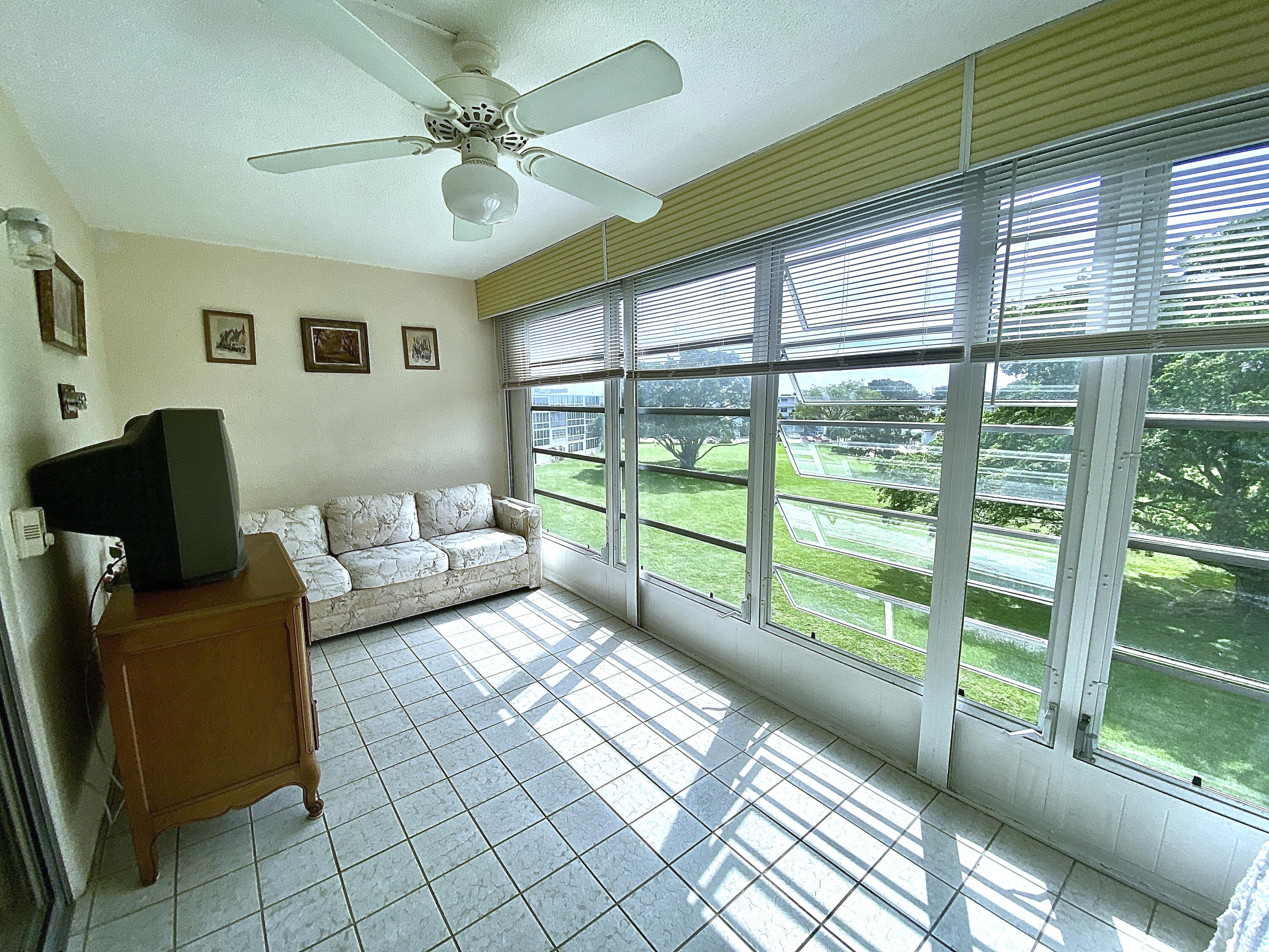 a living room with furniture and a floor to ceiling window