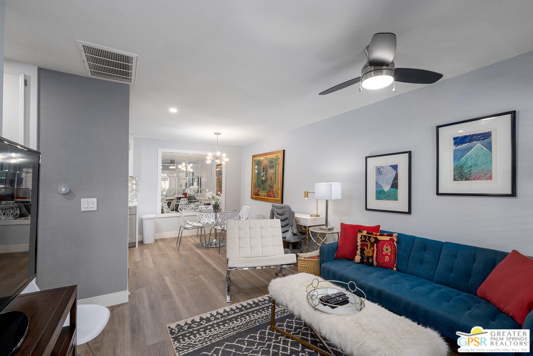 a living room with furniture and a wooden floor