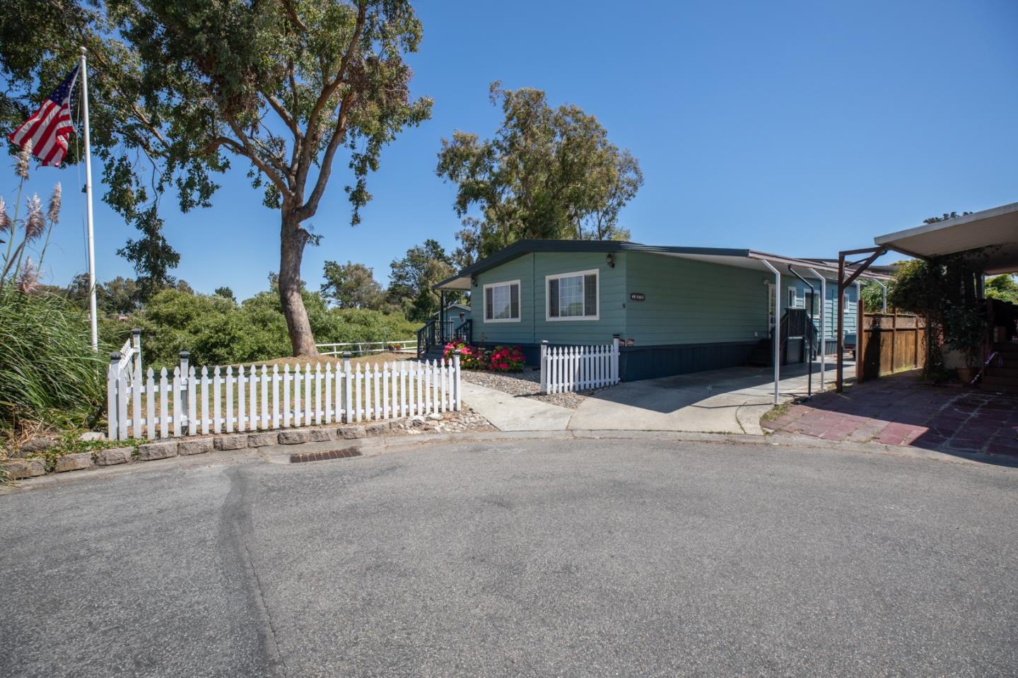 a view of a house with a yard and wooden fence