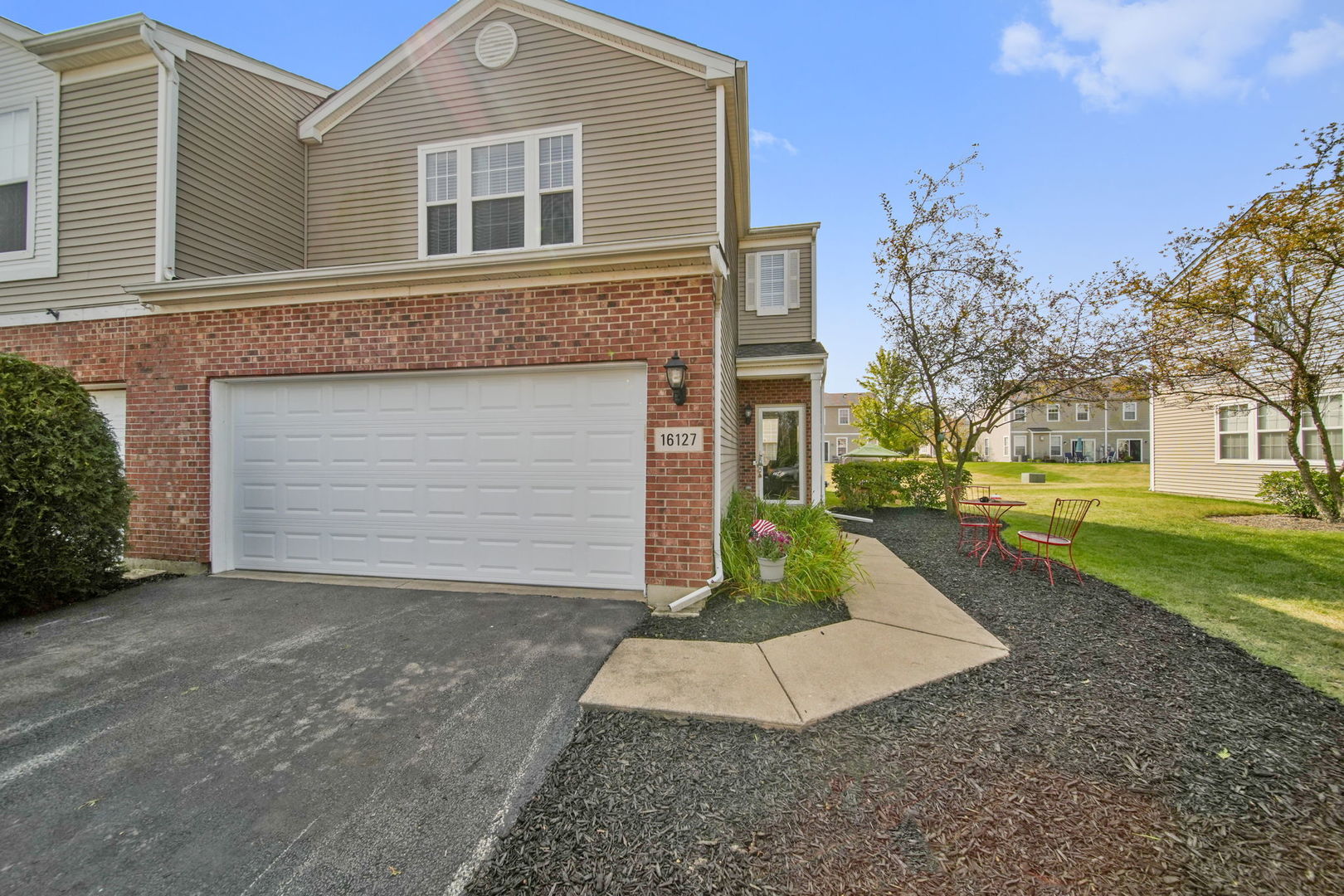 a front view of a house with a yard and garage