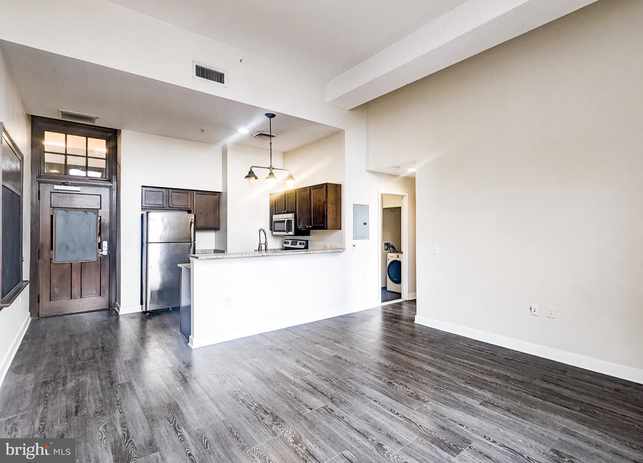 a view of living room with furniture and wooden floor