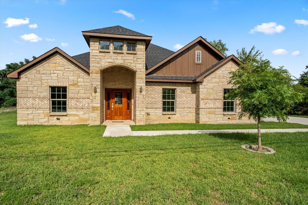 a front view of a house with a yard and garage