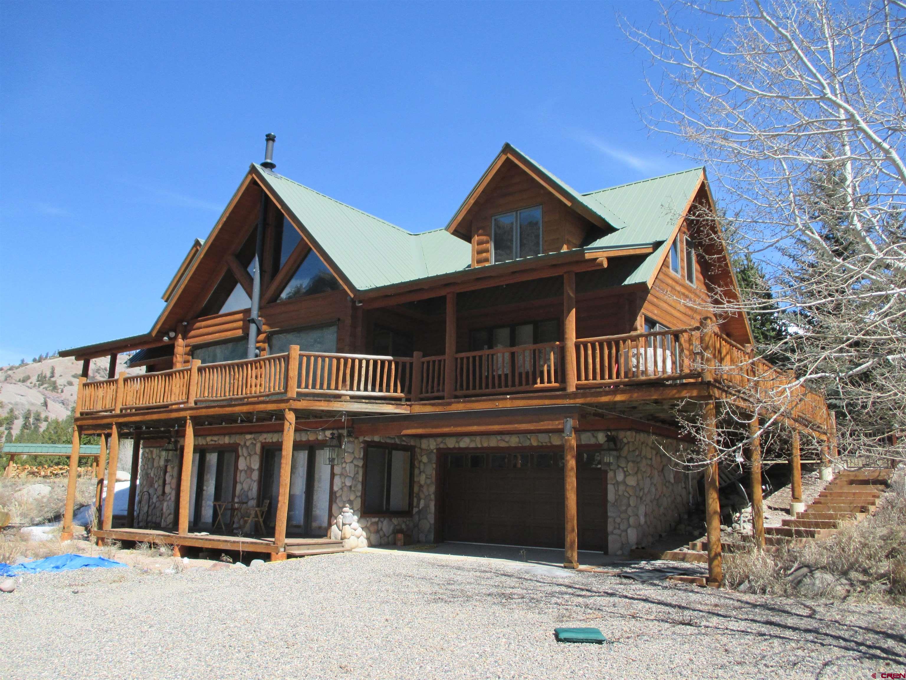 a view of a house with wooden fence