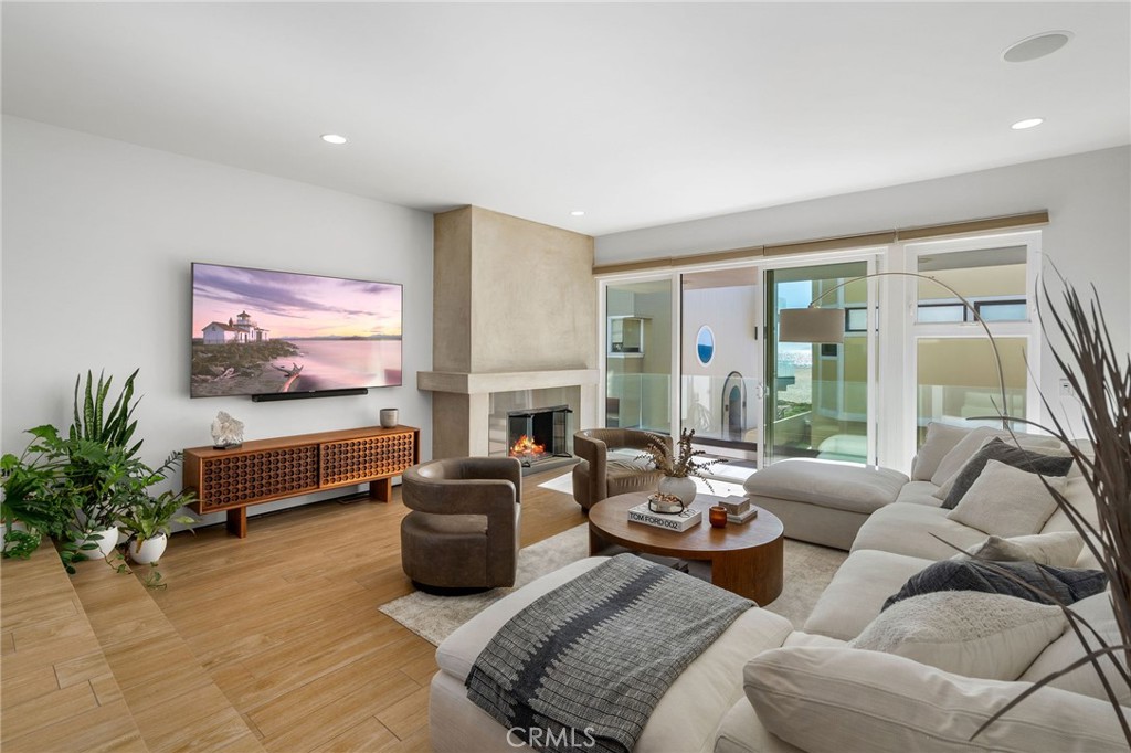 a living room with furniture a fireplace and a flat screen tv