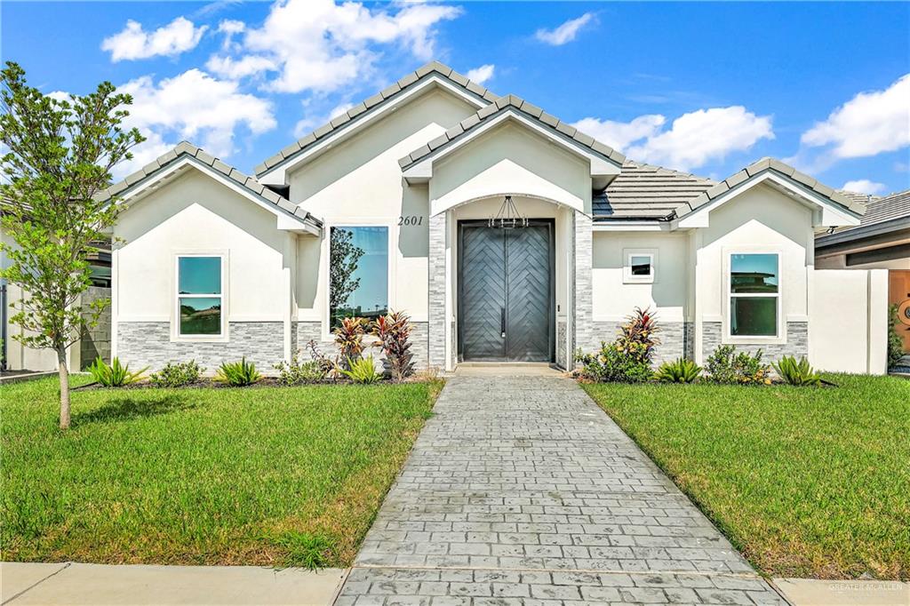 a front view of a house with a yard