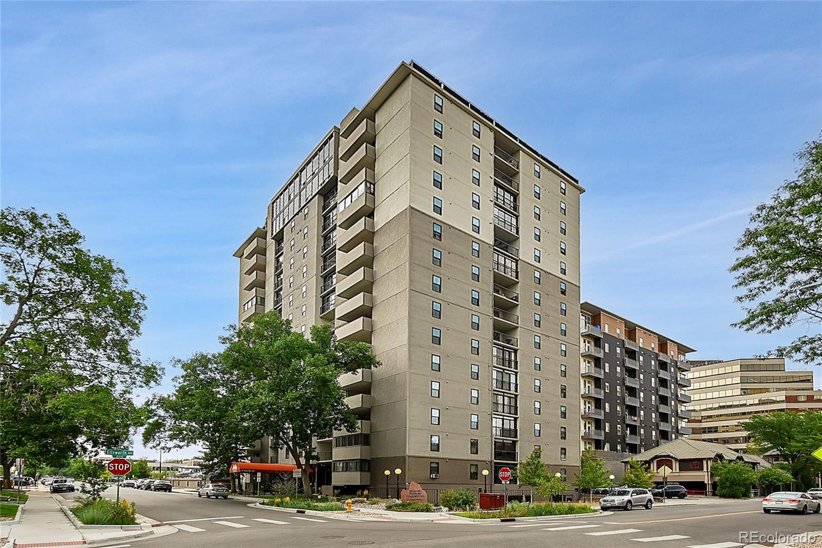 a view of a tall building next to a road